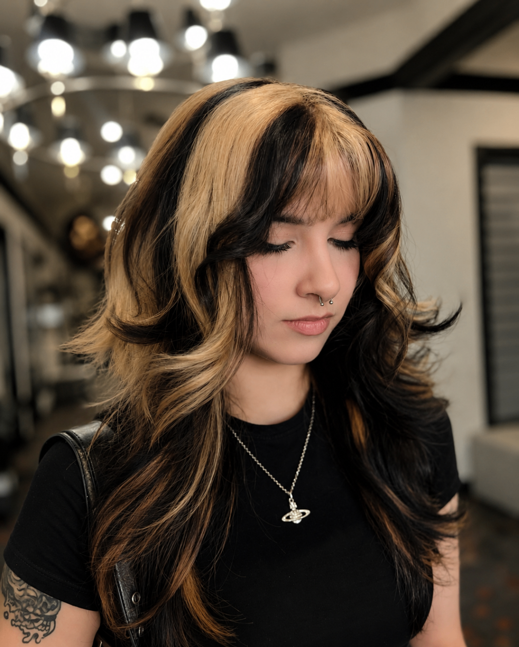 Black hair with bold blonde money pieces and layered cut