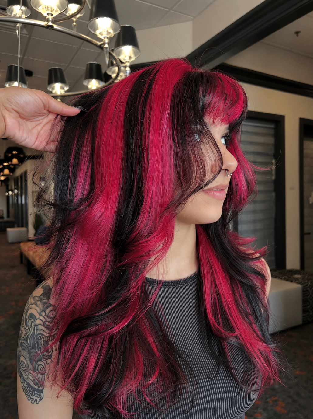 Black hair with vivid pink panel color and layered styling