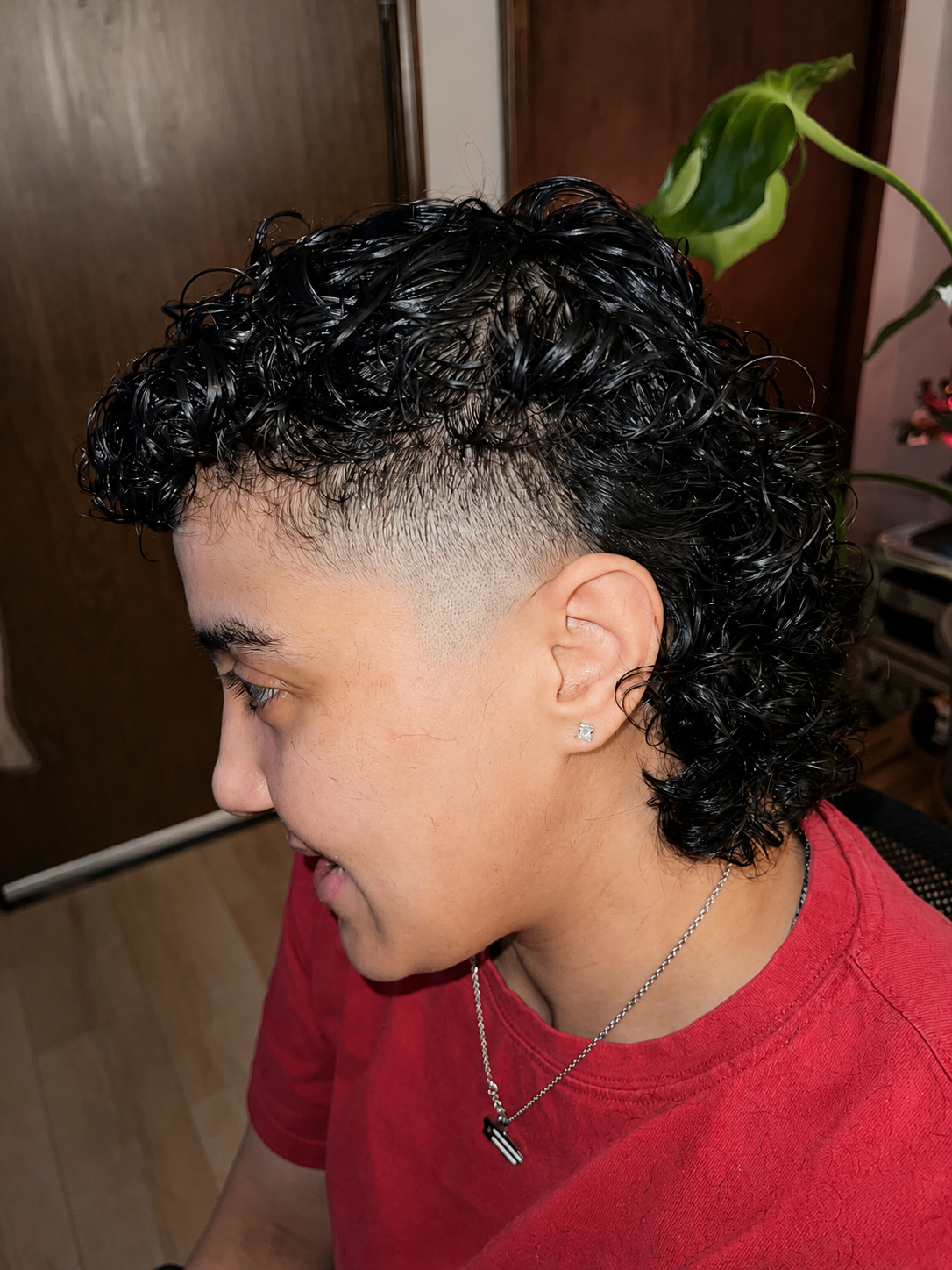 Curly mullet fade with clean sides and textured curls